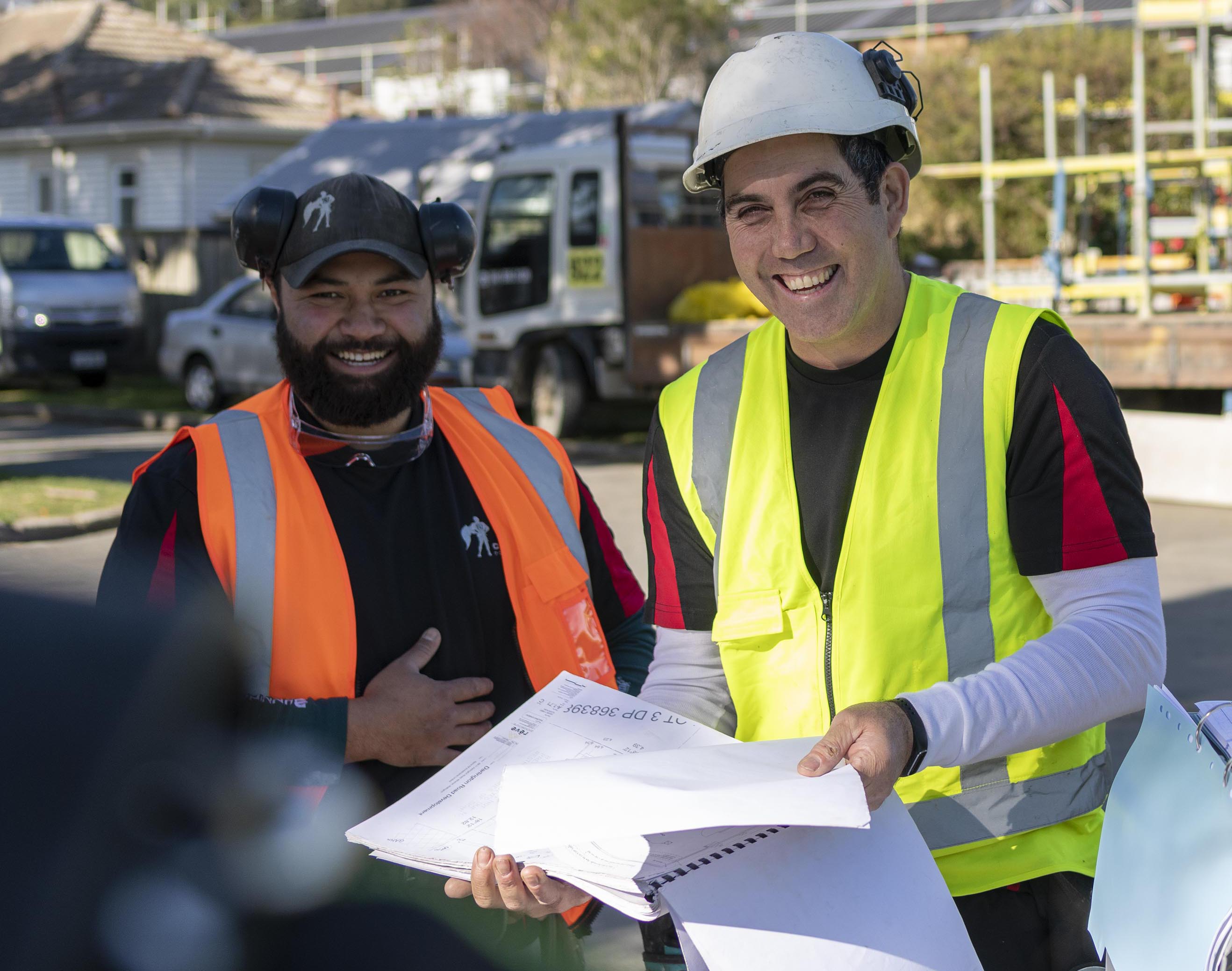 Builders on site with hard hats and hi vis