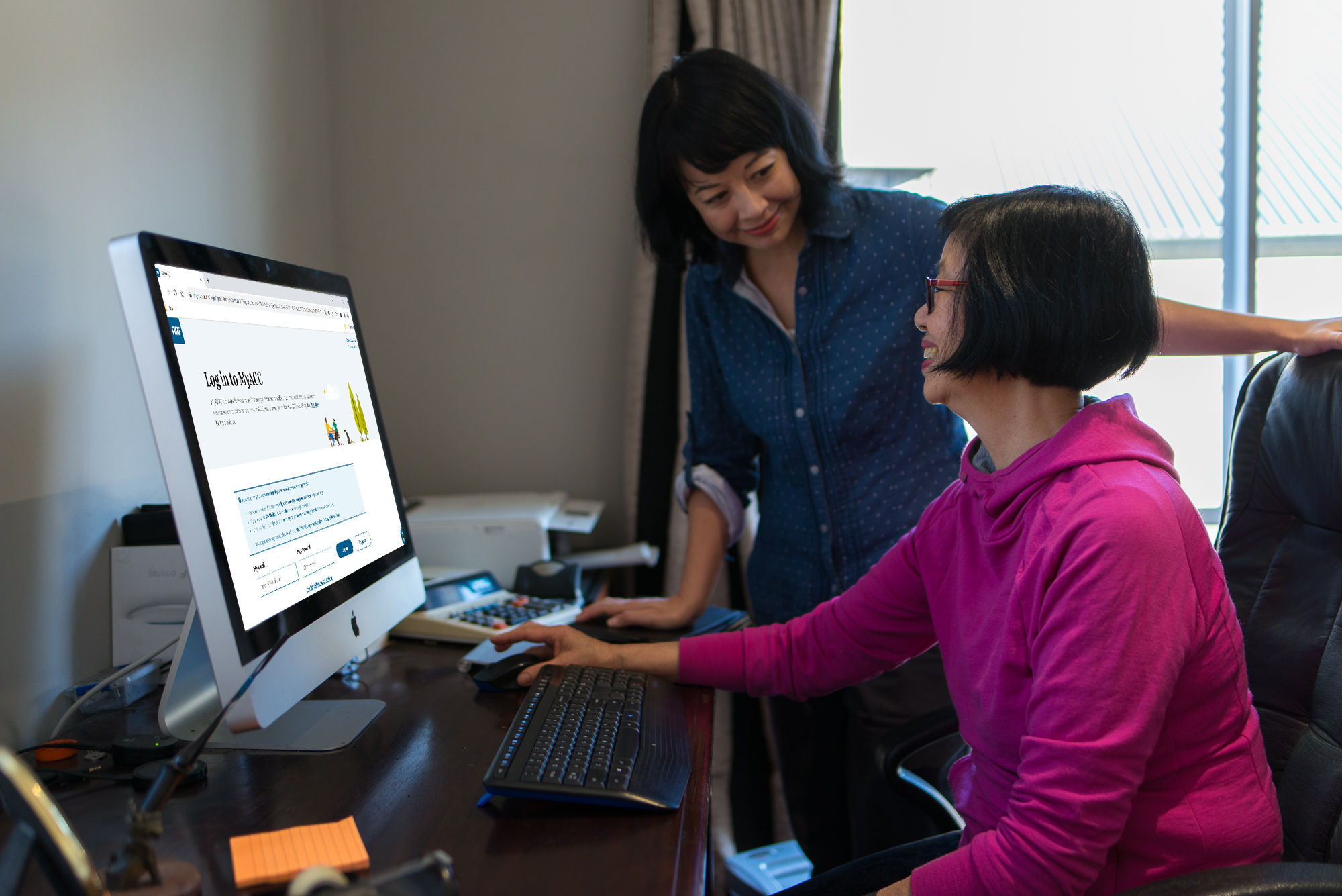 Two women at table on laptop