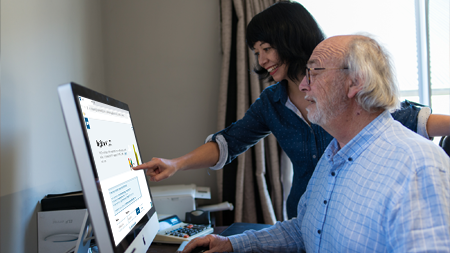 Person at desk reading on a computer screen