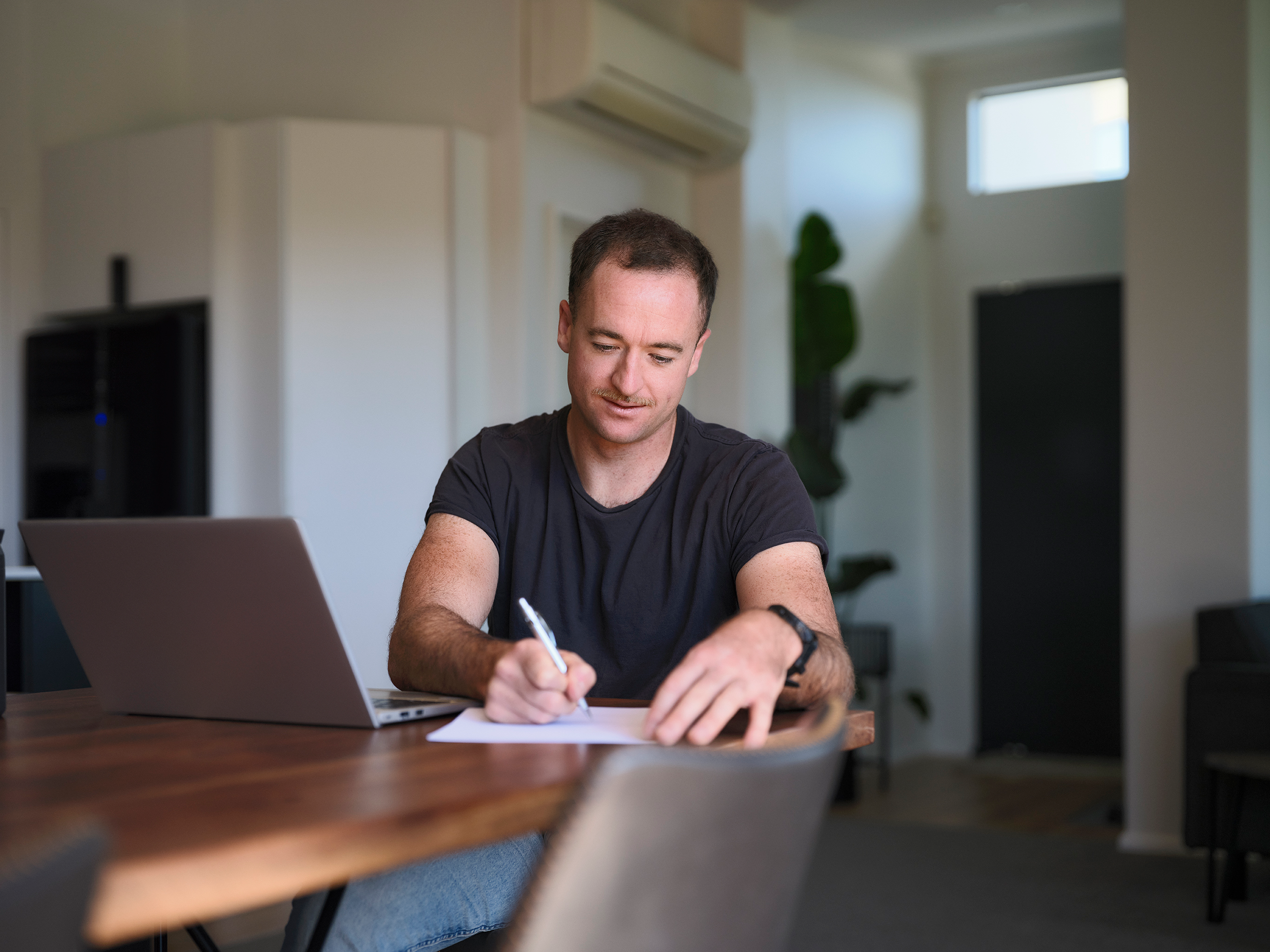 Person reading on laptop sitting at table