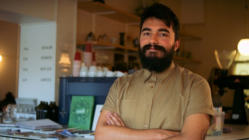 smiling cafe owner arms crossed