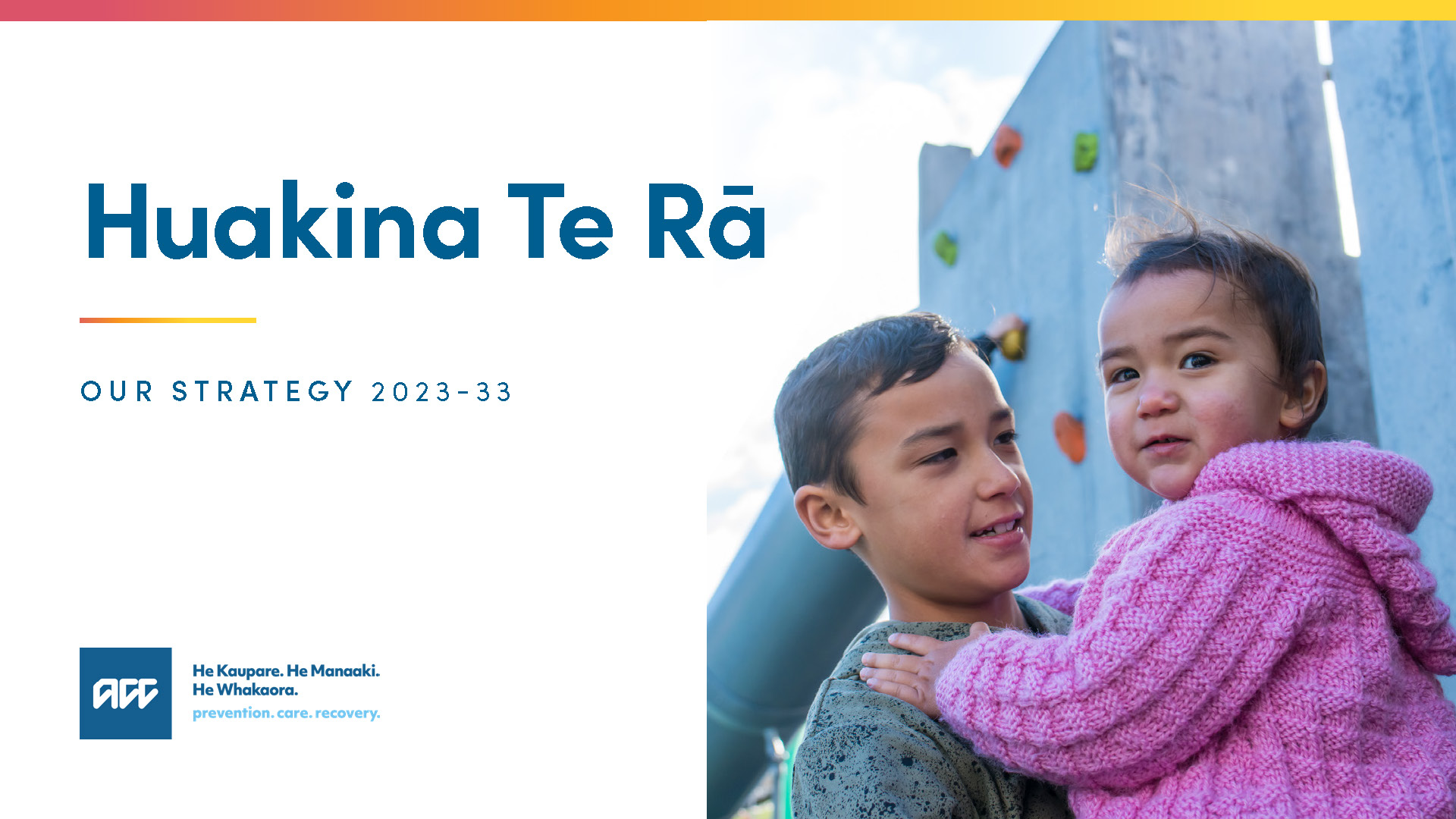 Young child holding toddler sibling with text Huakina Te Rā