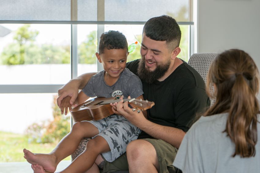 Father and children playing guitar