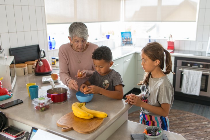 Grandmother prepares food with Grandkids