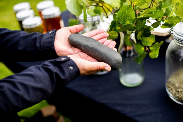 Woman holds rongoa Maori healing tools