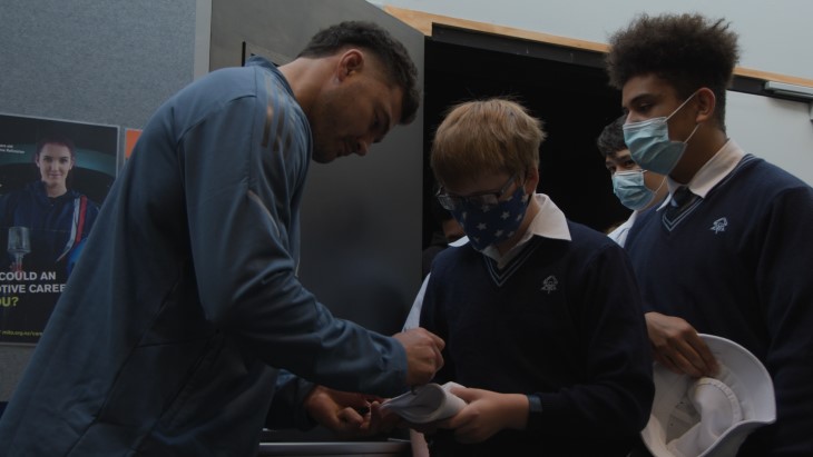 David Havili signs a student's gear