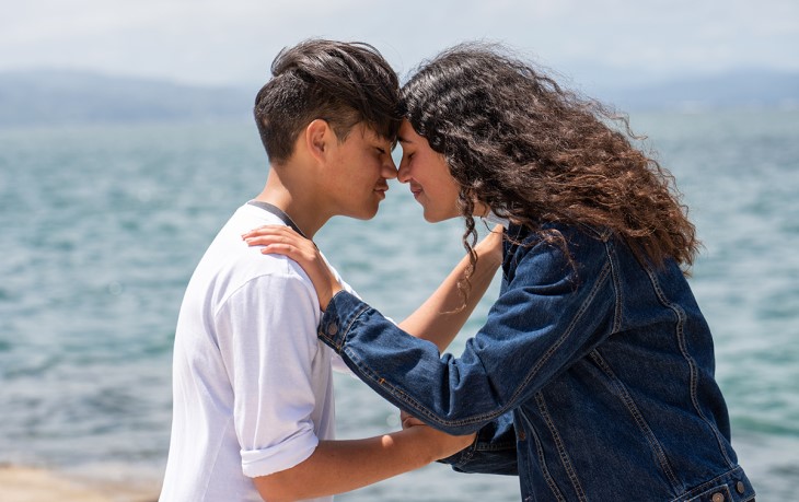 Two Māori teenagers share a hongi (Māori greeting)