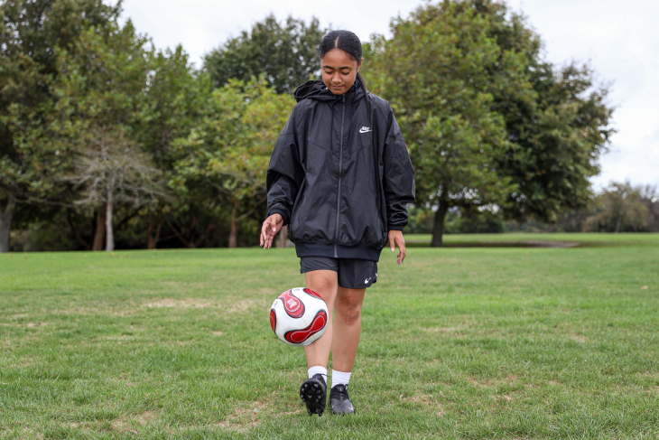 Carla kicks a football