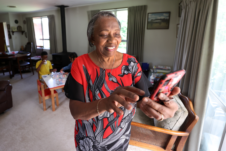 An older woman using the Nymbl app on her phone. 