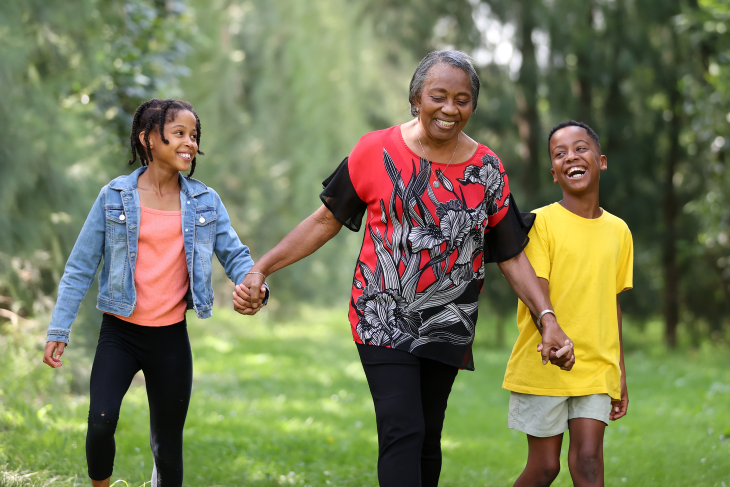 Dorothy Fitzpatrick walking in the park with her grandchildren.