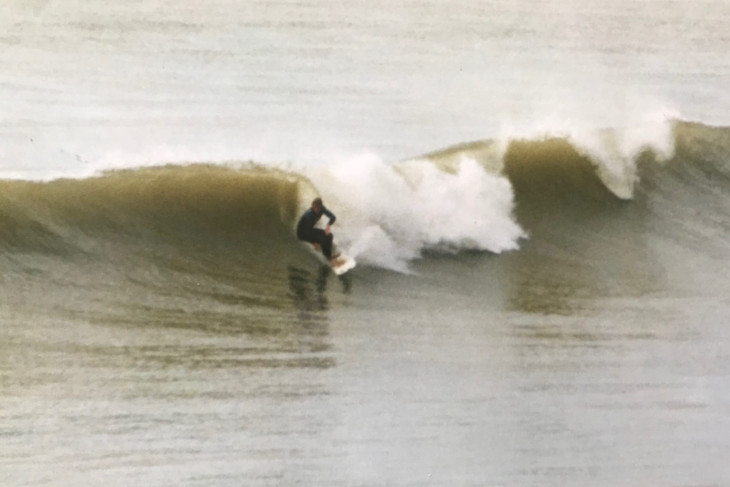 Goofy foot surfer Dr Johnny Bourke getting ready to pull into a backhand barrel