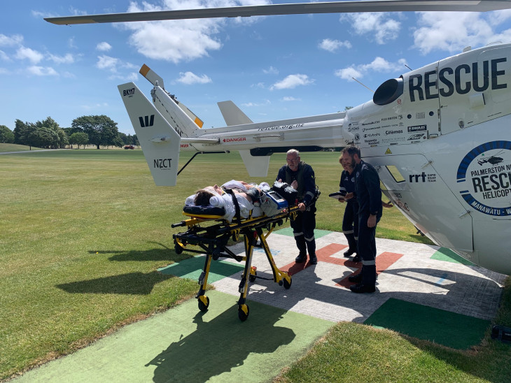 A young man on a stretcher is airlifted to hospital 