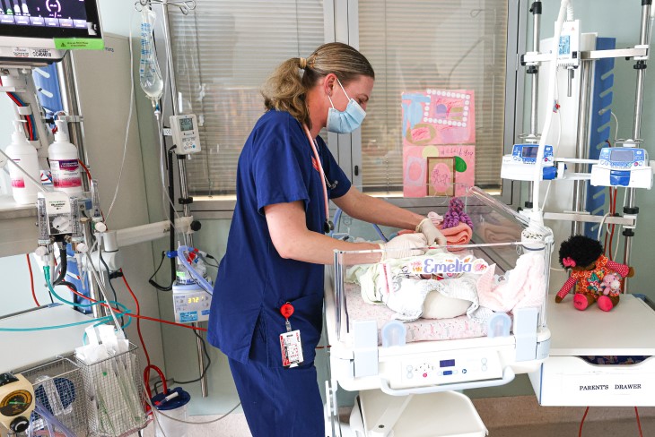 Lydia attends to a baby in the natal intensive care unit