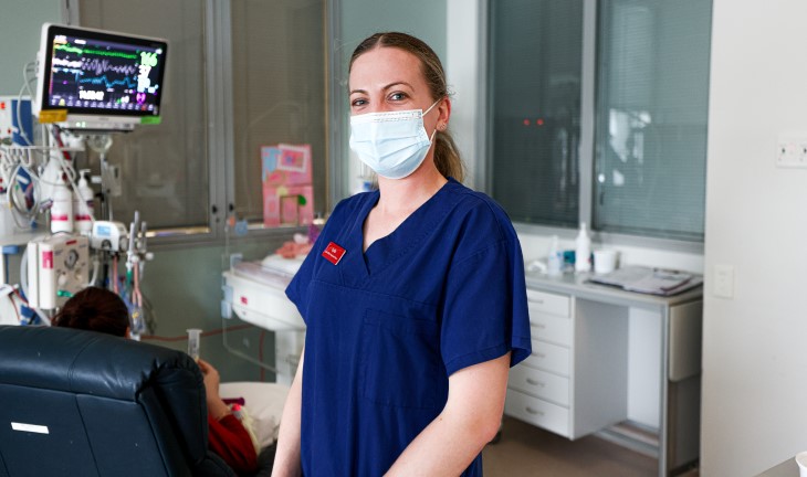 Lydia has her photo taken in the nurse uniform at the hospital, with a mask on her face