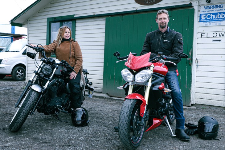 Mandy and her husband sit atop their motorbikes