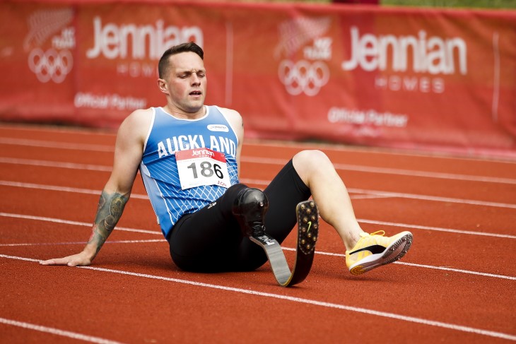 Mitch sitting on the ground on the track.