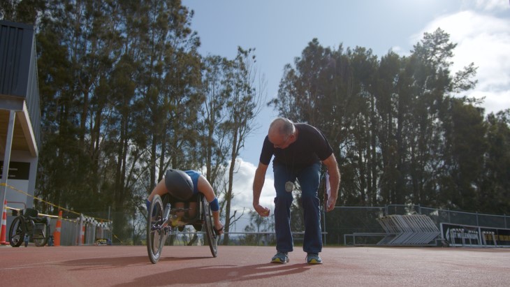 Para athlete and his coach on the track.