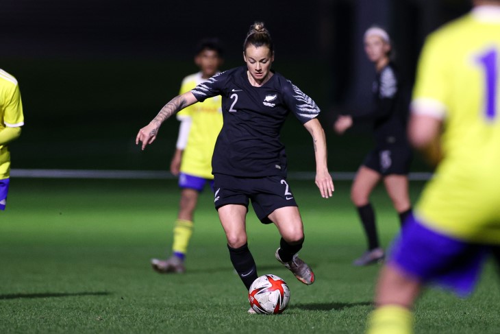 Ria on the pitch dribbling a ball.