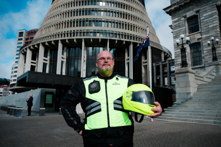 Ross Gratton smiles in front of the Beehive