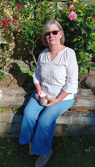 Sarah Pollard sitting on a bench outside