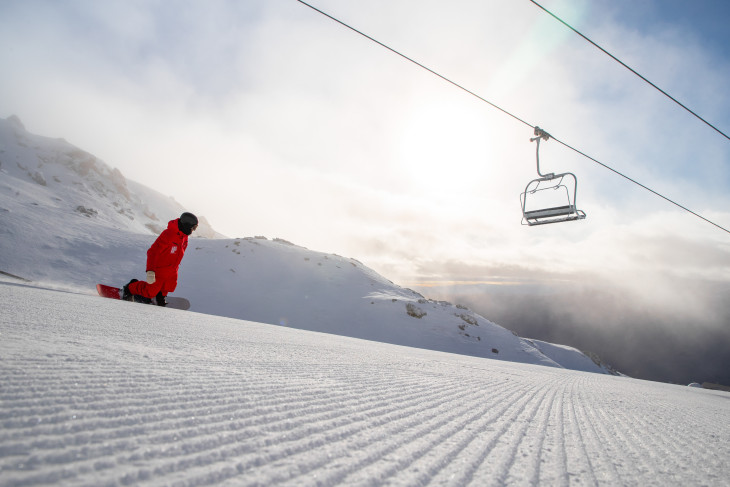 Skiier heading down slope