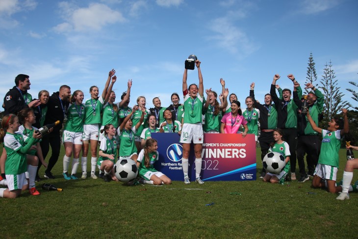 Stacey and her Hibiscus Coast football team pose for a photo with the league cup.