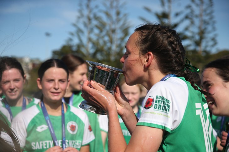 Stacey drinks out of the Carol Waller Cup.