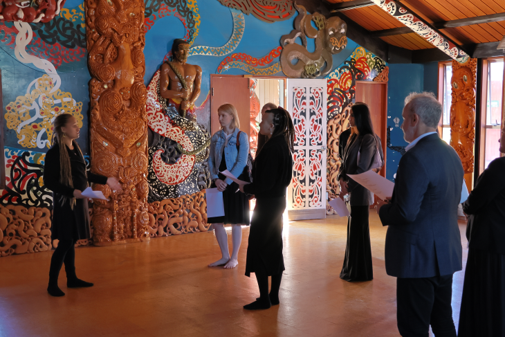 Kaimahi from Active+ talking to a member of Te Kōhao Health in a whare during a cultural day.
