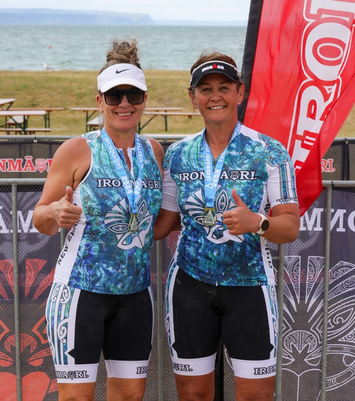 Amanda Hita with training partner and friend Lisa Chittick after IronMāori, posing with their medals.