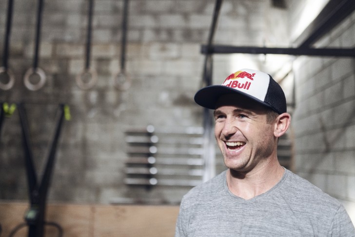 A close-up photo of Brook Macdonald smiling wearing a baseball cap.