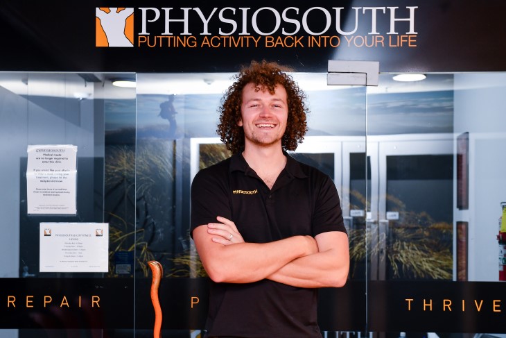 Physio Cameron James standing in front of the Physiosouth building. 