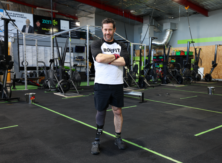 Craig Harrington standing at the gym with his arms folded and looking at the camera.