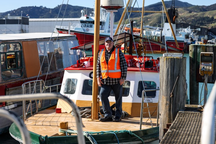 Former fisherman Darren Guard standing on the deck of a boat. 