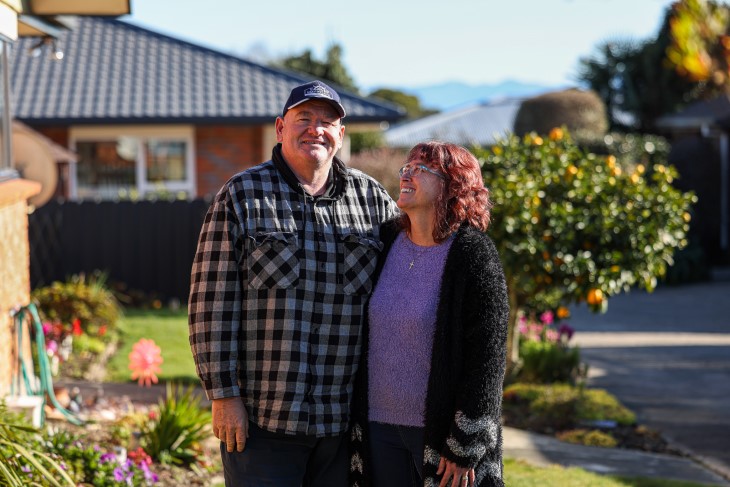 Darren Guard standing with his wife Karen in the garden outside a house.