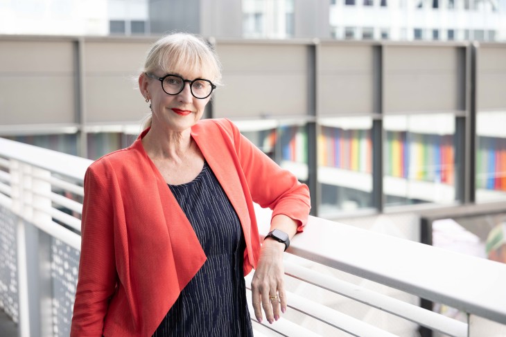 Dr Jo Prendergast standing casually at a balcony.