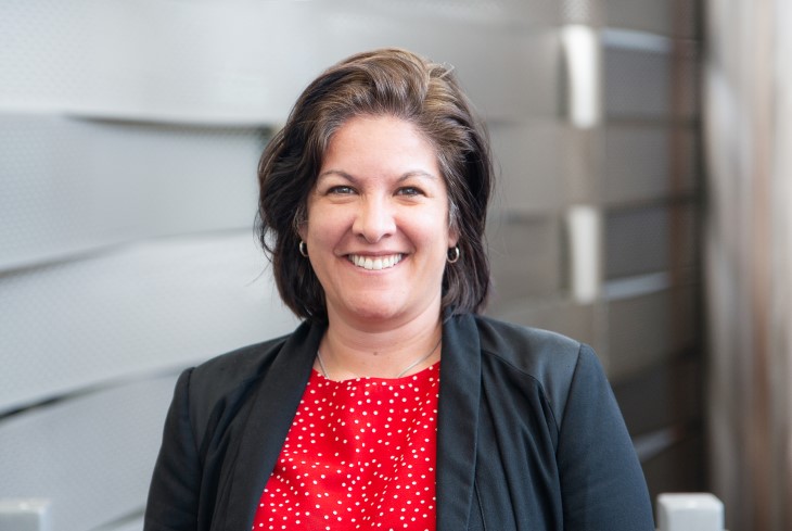 A portrait photo of Active+ Chief of Clinical Services Erin Holland smiling at the camera.