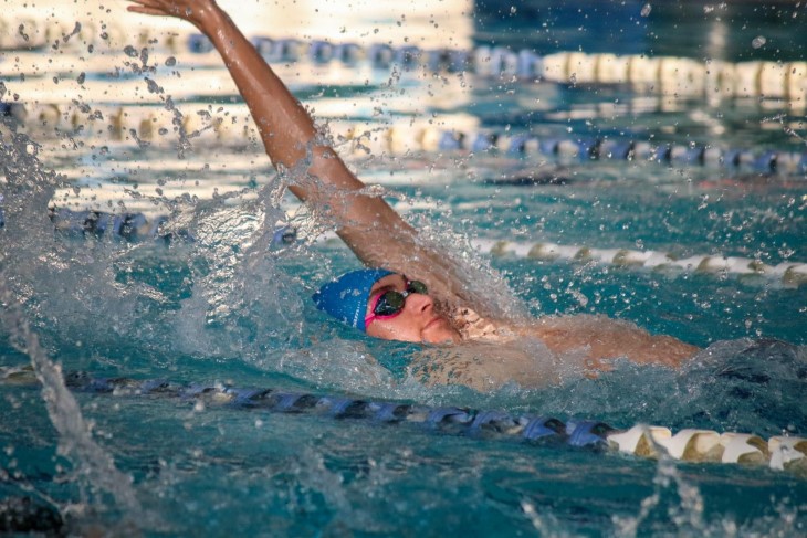 Guy Harrison doing the backstroke in a swimming pool. 