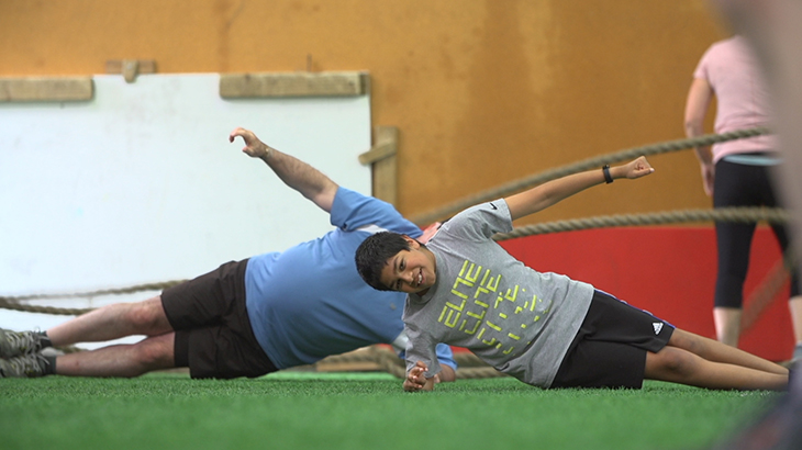 Members of the fitness group do sideways planks