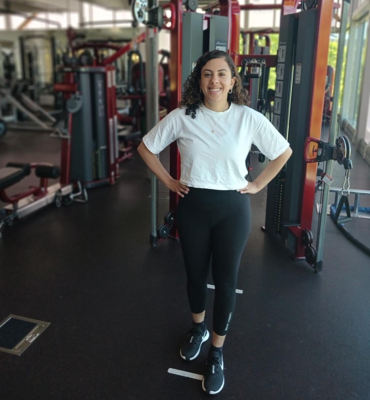 Hala standing in the gym and smiling.