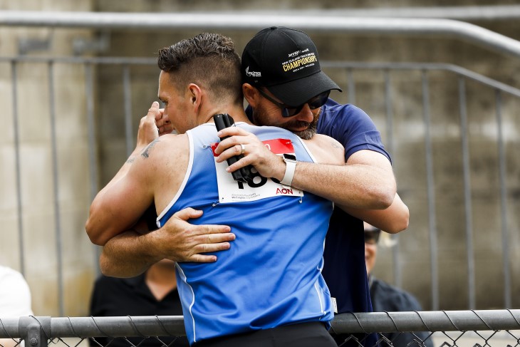 Para sport coach Hamish Meacheam hugging one of his athletes after a competition. 