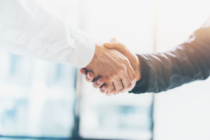 Two people shaking hands. 