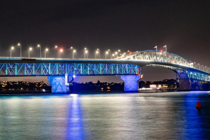 The Auckland Harbour Bridge illuminated with blue lights to celebrate Matariki. 