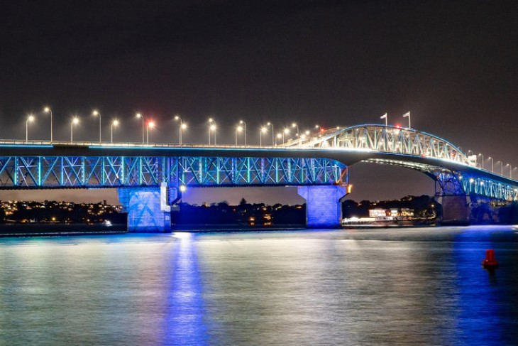 The Auckland Harbour Bridge illuminated with blue lights to celebrate Matariki.