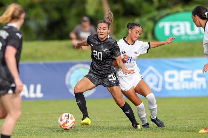 Indiah-Paige Riley holding off the challenge of an opponent during a match for the Football Ferns.
