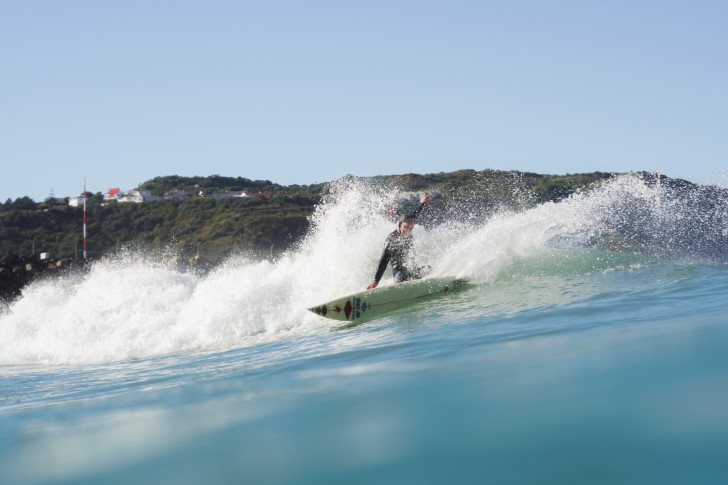 James Whitaker surfing on a wave.