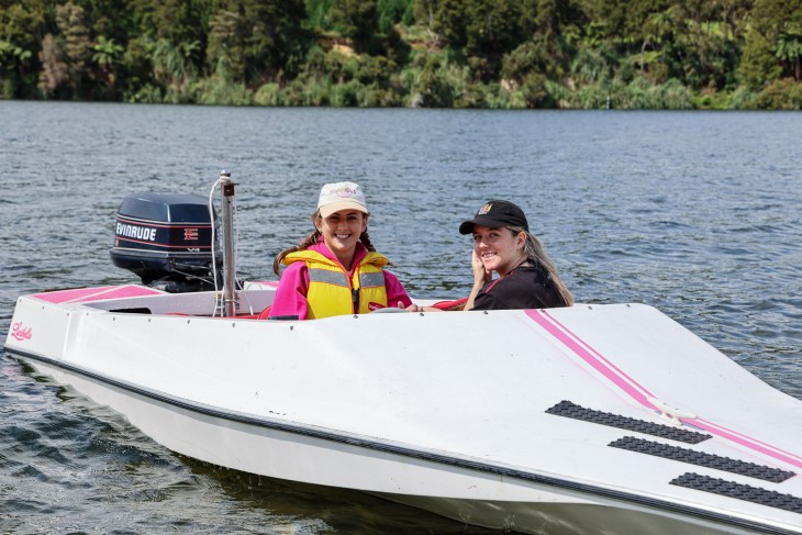 Jamie Astwood driving her ski boat with her sister Holly.