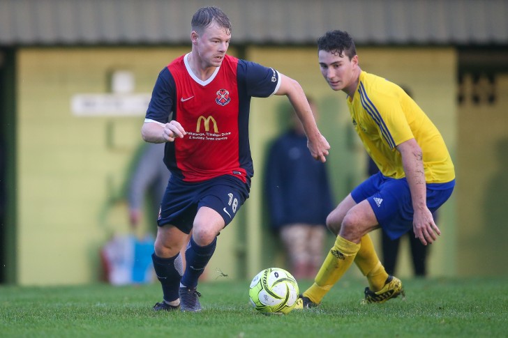 Jarrod Young with the ball dribbling past an opponent.
