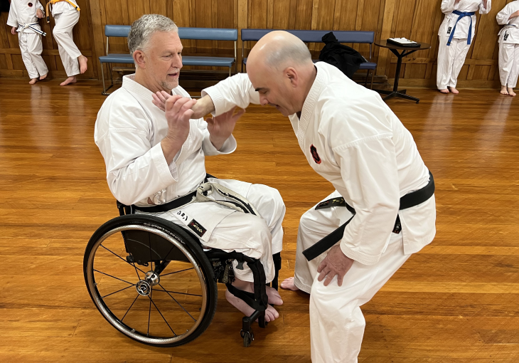john marrable 1 John Marrable doing karate training in his wheelchair with another man, who is standing up.
