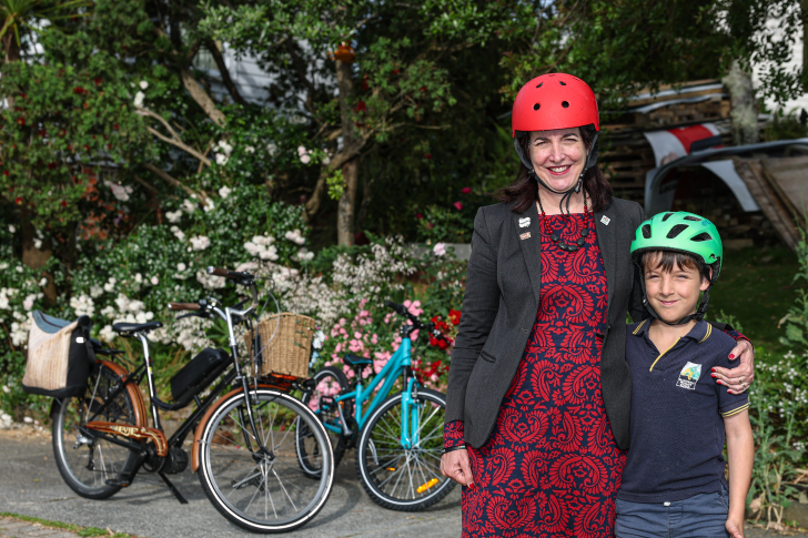 Julie Fairey standing with her son in front of a pair of bikes.