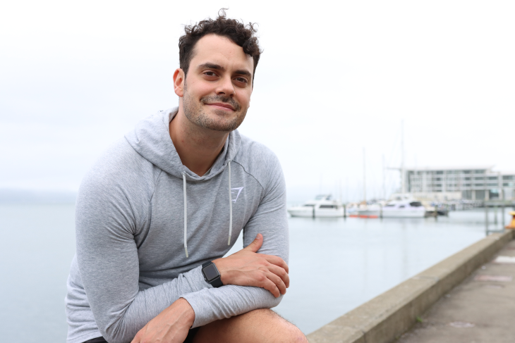 Liam Olson poses on Wellington's waterfront. 